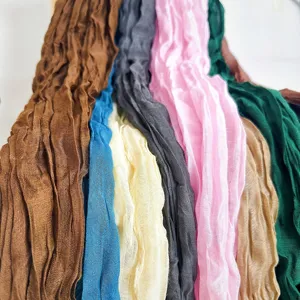 Close-up detail of multi-color crinkled linen cotton scarves, lightweight autumn fabric.
