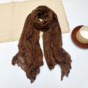 Brown polka dot wrinkled cotton linen scarf, detailed texture and stylish accessory.