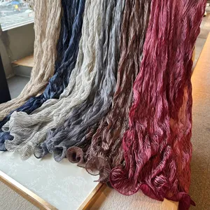 Close-up detail of multi-color pleated crinkled scarves showing texture and color range.