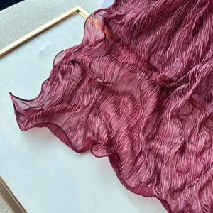 Detailed view of the dark red pleated scarf texture, elegant and breathable fabric.