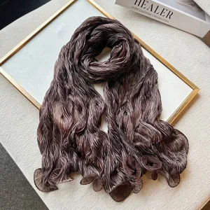 Brown crinkled long scarf detail showing pearlescent wavy texture and lightweight fabric.