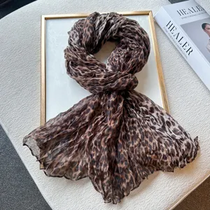 Detailed view of the stylish leopard print crinkle scarf, showing soft textured fabric texture.