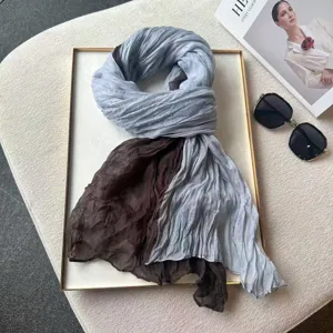 Detail view of fashion two-tone pleated scarf, stylish color-block design for autumn winter.
