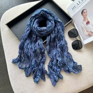 Detailed close-up of a blue crinkled cotton linen scarf featuring vintage pattern.