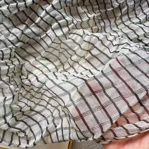 Close up view of women pleated striped long scarf fabric showing delicate texture and sheer.