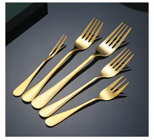 Close-up of golden stainless steel forks set, polished finish, premium cutlery details.