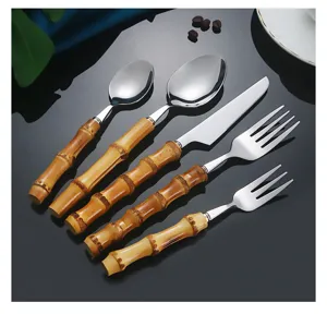 Detail view of a 5-piece stainless steel cutlery set with elegant bamboo handles.