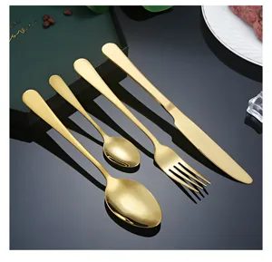 Elegant luxury gold stainless steel flatware cutlery set detail view with spoon and fork.