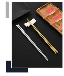 Stainless steel square chopsticks set with ceramic rest and wooden sushi tray detail.
