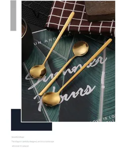 Gold stainless steel small round spoon for coffee stirring, dessert, and honey. Detail view.