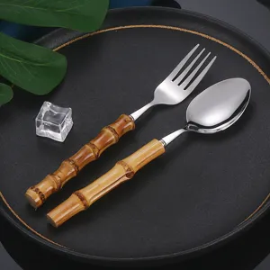 Stainless steel fork and spoon set with bamboo handle for steak and western dining table.