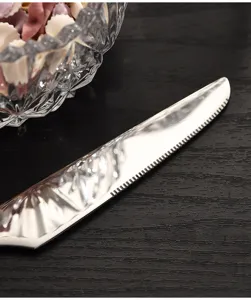 Stainless steel western table knife detail shot, elegant wasp waist design, premium cutlery.
