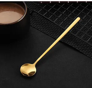 Gold stainless steel small round spoon tableware close up, delicate design for coffee mixing.
