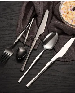 Stainless steel cutlery set detail, sleek metal handle, polished finish for fine dining.