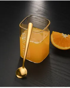 Gold stainless steel short spoon detail view for coffee, dessert, and honey tasting.