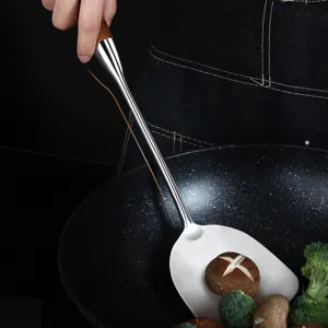 Stainless steel cooking spatula with wooden handle for kitchen use, durable and practical main tool.