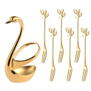 Golden swan holder with six leaf fruit forks detail, elegant stainless steel tableware.