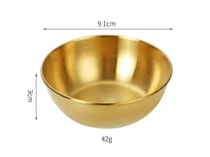 Detailed close-up shot of the golden stainless steel dipping bowl showing fine brushed texture.