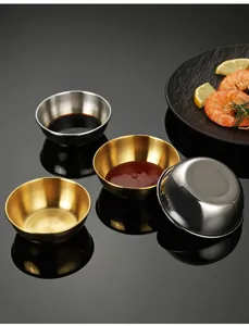 Detail shot of stainless steel dipping bowls in gold and silver, perfect for kitchen use.