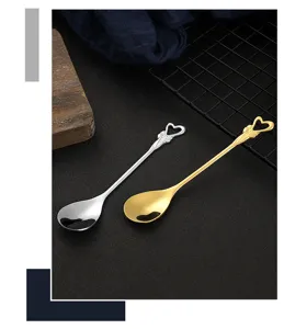 Stainless steel coffee spoon with hollow heart handle and elegant bow design for dessert.