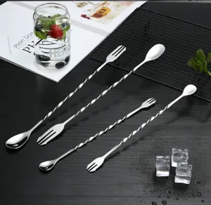 Stainless steel long handled cocktail bar spoon with fork end, perfect for mixing drinks.