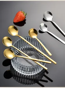 Detailed view of mini stainless steel dessert spoons in gold and silver, ideal for coffee.