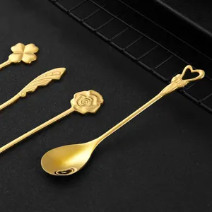 Gold stainless steel coffee spoons set featuring creative clover and rose handle designs.