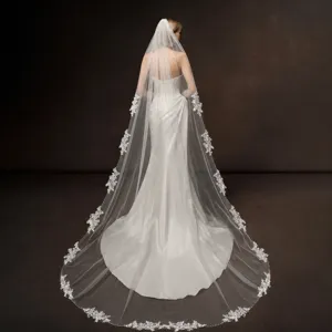 Elegant long bridal veil featuring exquisite lace trim and hand-sewn beaded details for weddings.