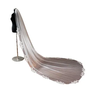 Elegant long wedding veil with delicate lace trim bridal headpiece for special day.