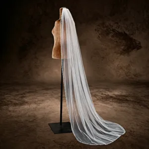 Elegant single-layer cathedral wedding veil with hand-sewn beaded lace edge for brides.