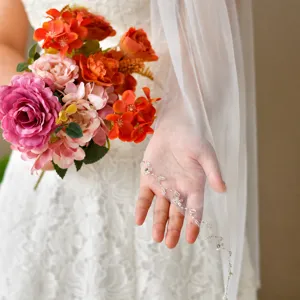 Detailed close-up of exquisite bridal wedding veil featuring hand-stitched beaded lace trim.