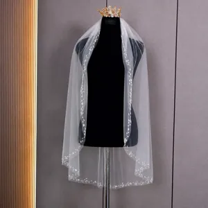 Elegant white single-layer wedding veil featuring exquisite hand-sewn beaded lace edge design.