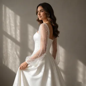 Elegant white bridal mesh sleeves with pearl embellishments for a stunning romantic wedding look.