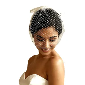 White rhinestone birdcage veil with satin bow headband for bridal and party vintage fashion.