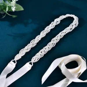 Bridal pearl belt detail, exquisite hand-woven pearls with elegant white satin ribbon for wedding.
