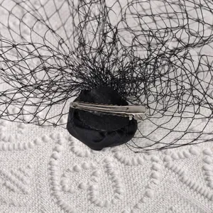 Detailed view of black bridal mesh veil fascinator hair clip, vintage french hair accessory.