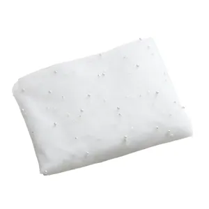 White pearl tulle mesh fabric for bridal veils and dress sewing, soft dotted material.