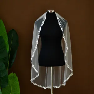 Elegant white bridal veil with embroidered leaf lace trim, perfect for rustic outdoor weddings.