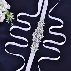 Handcrafted bridal rhinestone sash with white satin ribbon and blue pearls for wedding dress decor.
