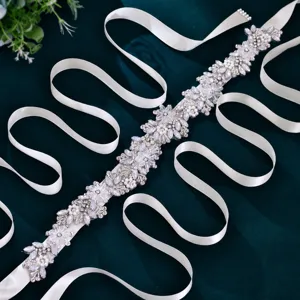 Exquisite bridal rhinestone belt detail, sparkling crystals and pearls on white satin ribbon.