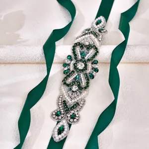 Emerald rhinestone bridal belt with green ribbon, exquisite wedding dress waist accessory.