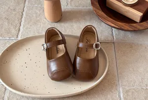 Brown toddler Mary Jane shoes detail shot, soft sole flat princess footwear design.