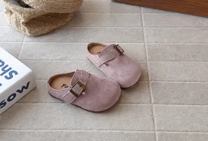 Detail view of kids retro pink suede clogs, comfortable slip-on half slippers with buckle.