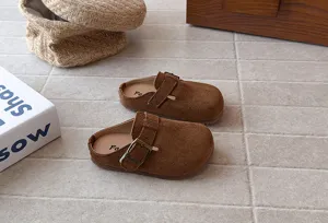 Kids brown suede clogs detail view, showing soft sole and adjustable metal buckle design.