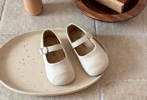Details of beige toddler Mary Jane flat shoes with cute strap and soft sole design.