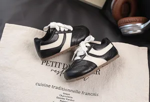 Kids retro German trainer sneakers, black and white contrast casual sports running shoes.
