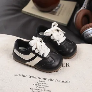 Kids retro casual sneakers for boys and girls, stylish black leather walking shoes with white details.