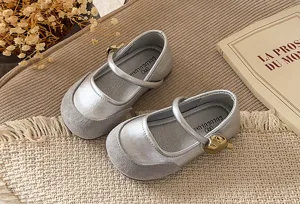 Kids French Mary Jane flat shoes, silver metallic upper with grey suede toe and strap design.