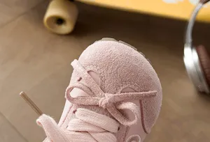 Detalle de zapatilla de ante rosa para niños, diseño de lazo bonito, zapato casual suave.