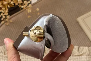 Soft leather girls shoes detail, flexible sole close-up shot, elegant gold metallic buckle display.